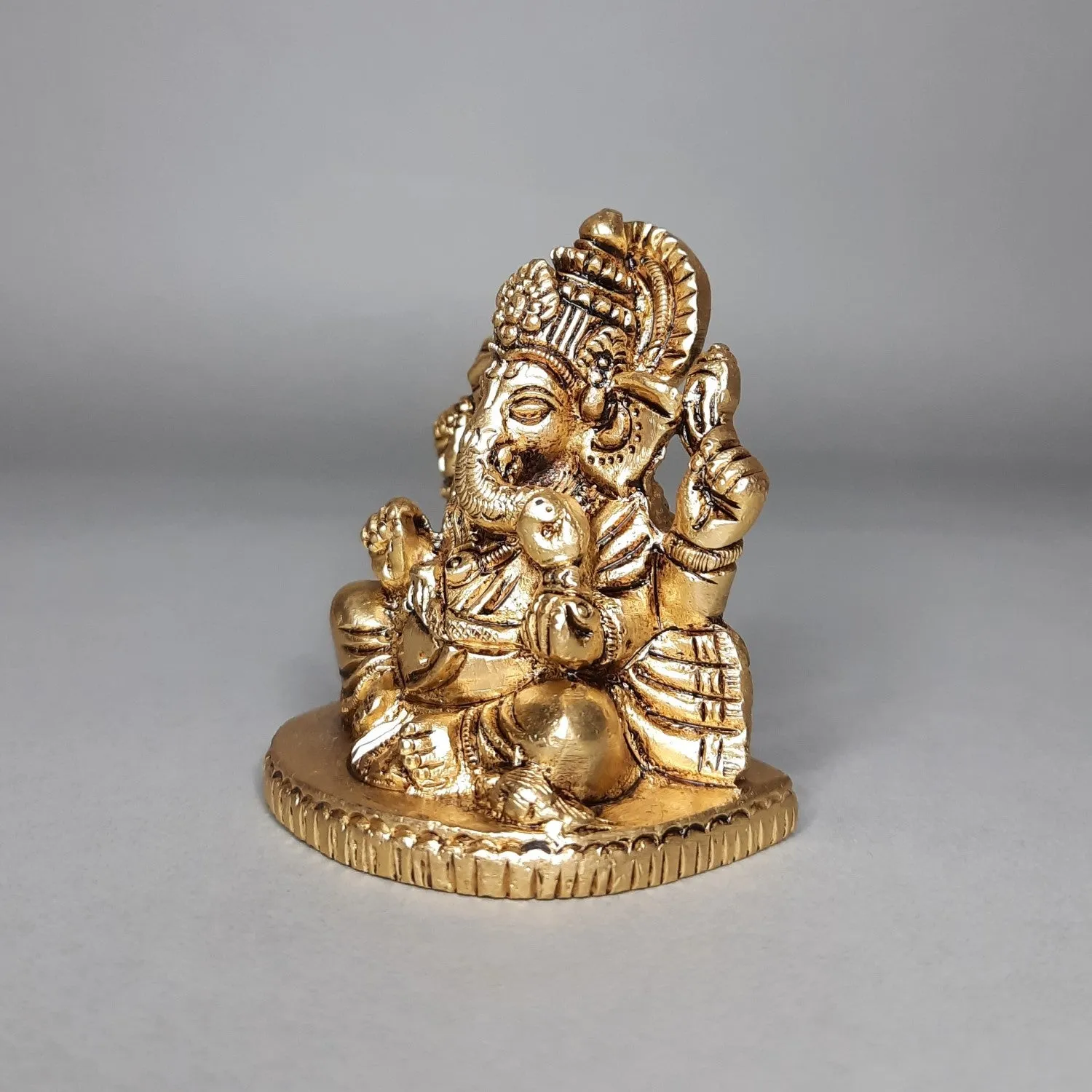 Brass Ganesha Sitting on Oval Base 2.5 in